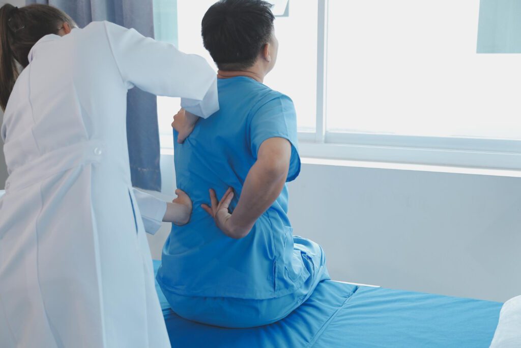 Doctor examining patients spine before surgery